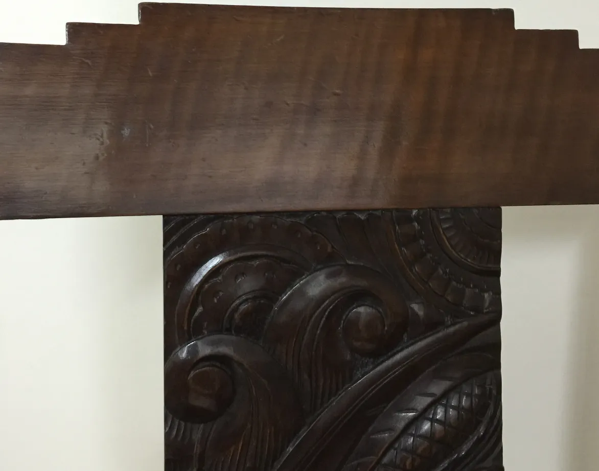 Antique desk chair with decorative carvings and elegant design in a neutral setting