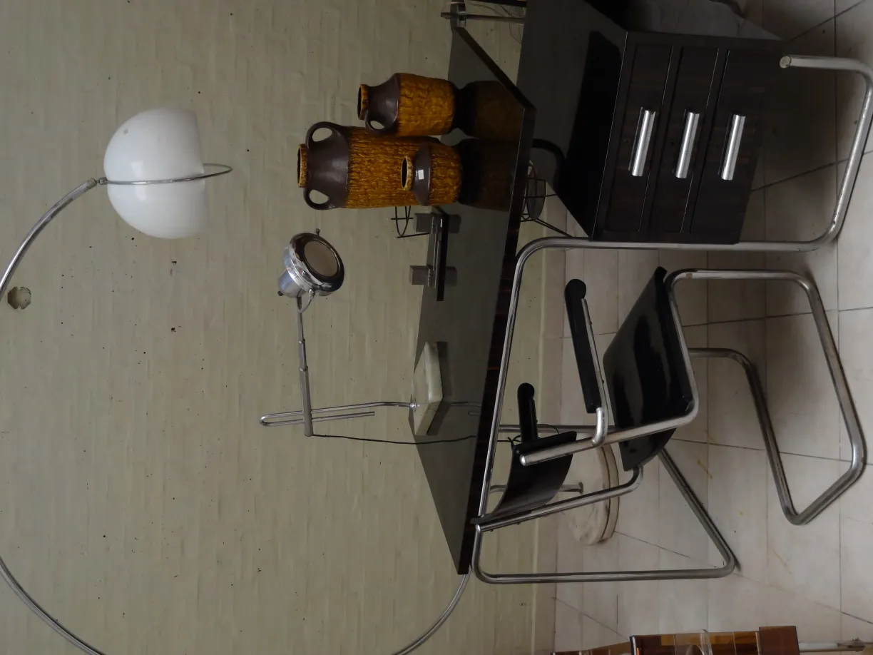 Antique desk chair with lamp and decorative items