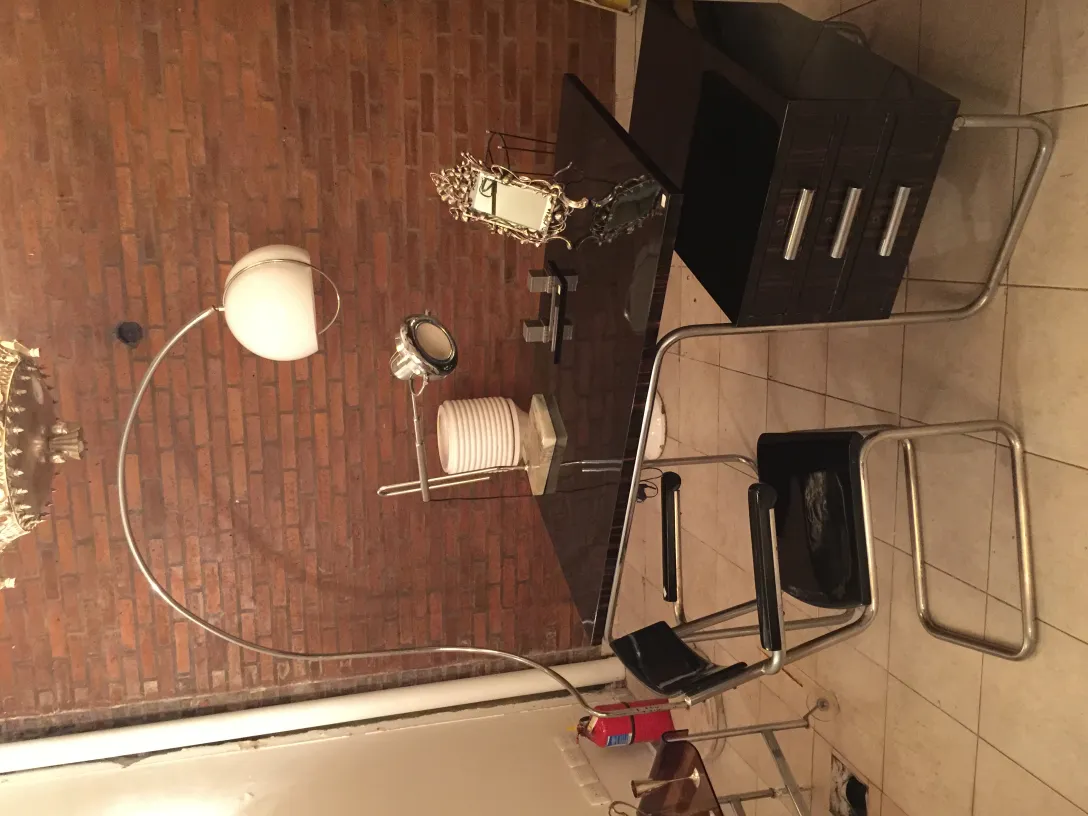 Antique desk chair with arms in a modern setting.