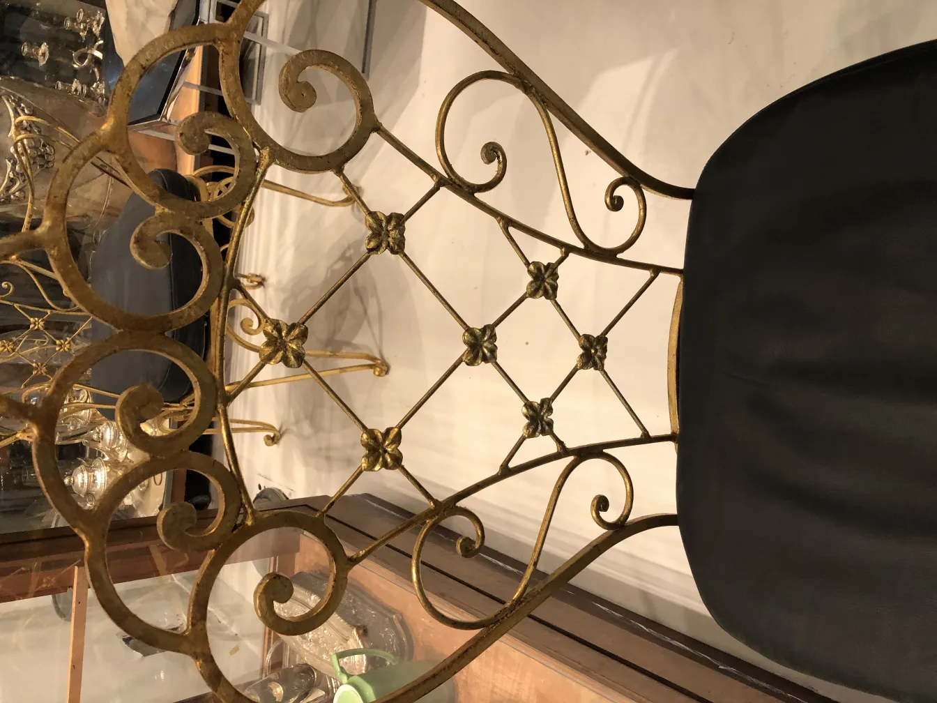 View of 2 antique chairs with decorative back design, set in an elegant environment.