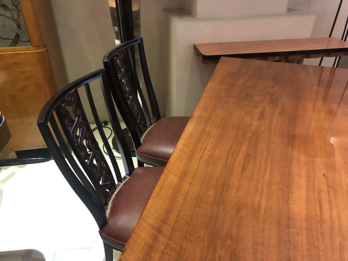 Images of 2 antique chairs, intricate details and a cozy environment.