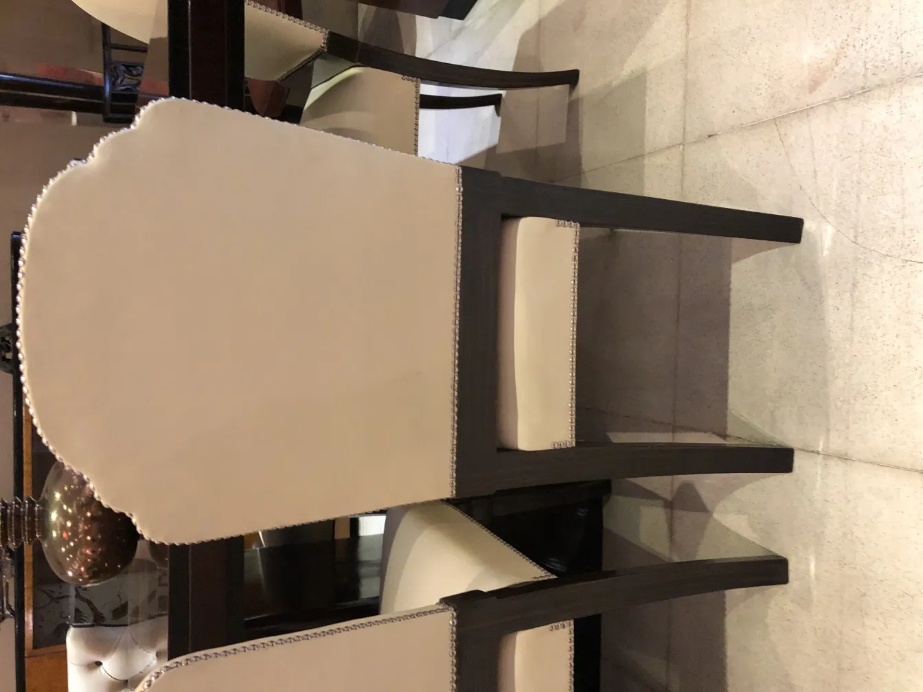 Six antique chairs with light upholstery in an elegant dining room