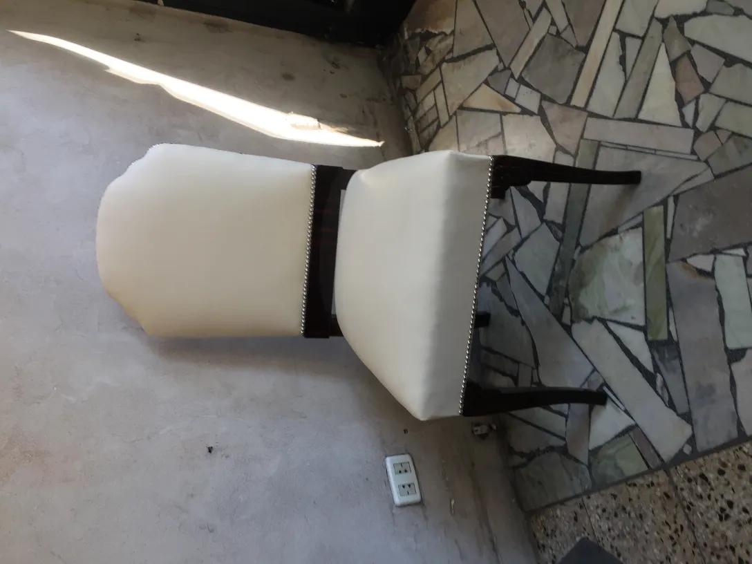 Six antique chairs featuring light upholstery in a stylish setting.