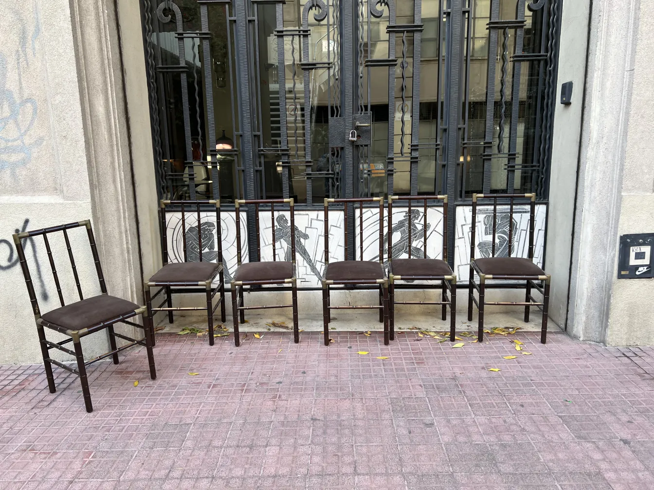 six antique chairs in an urban setting with fallen leaves