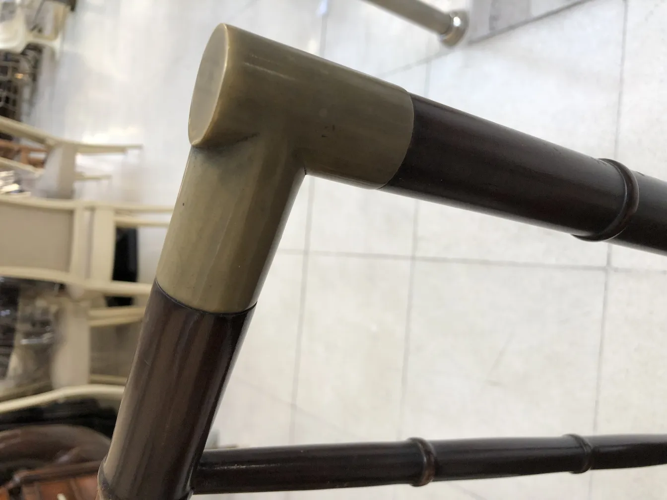 side view of an antique chair frame with decorative details