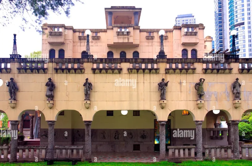View of 6 antique chairs in front of a building with statues