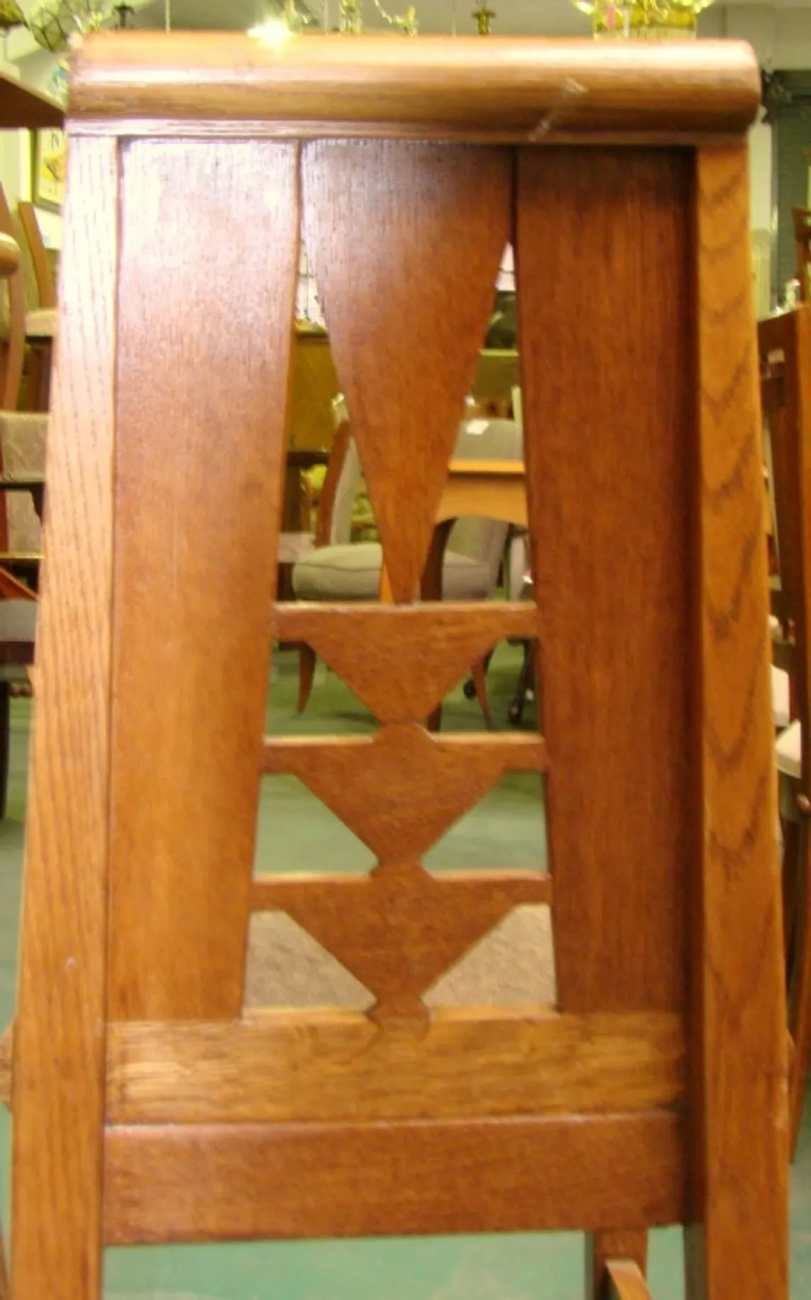 Side view of 6 antique chairs with decorative design in a cozy setting.