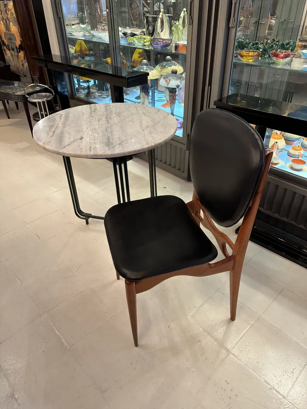 Set of 8 antique chairs, featuring an elegant finn juhl design, in a cozy setting with glass ornaments.