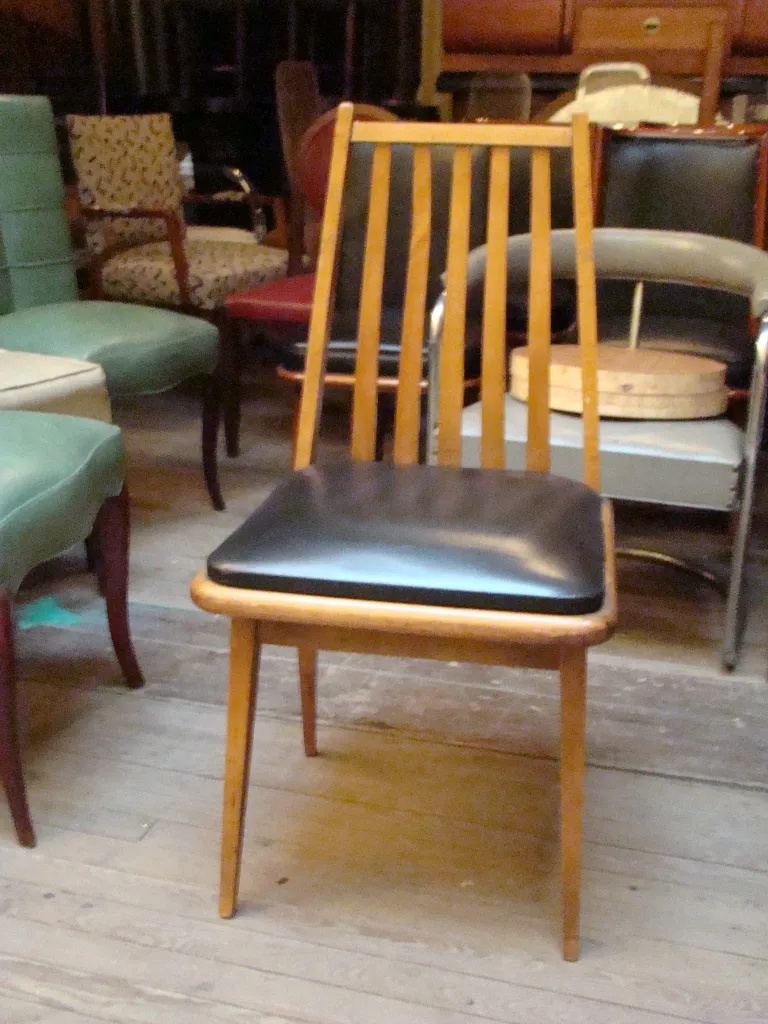 Eight antique chairs with elegant design and light colors in a cozy setting.