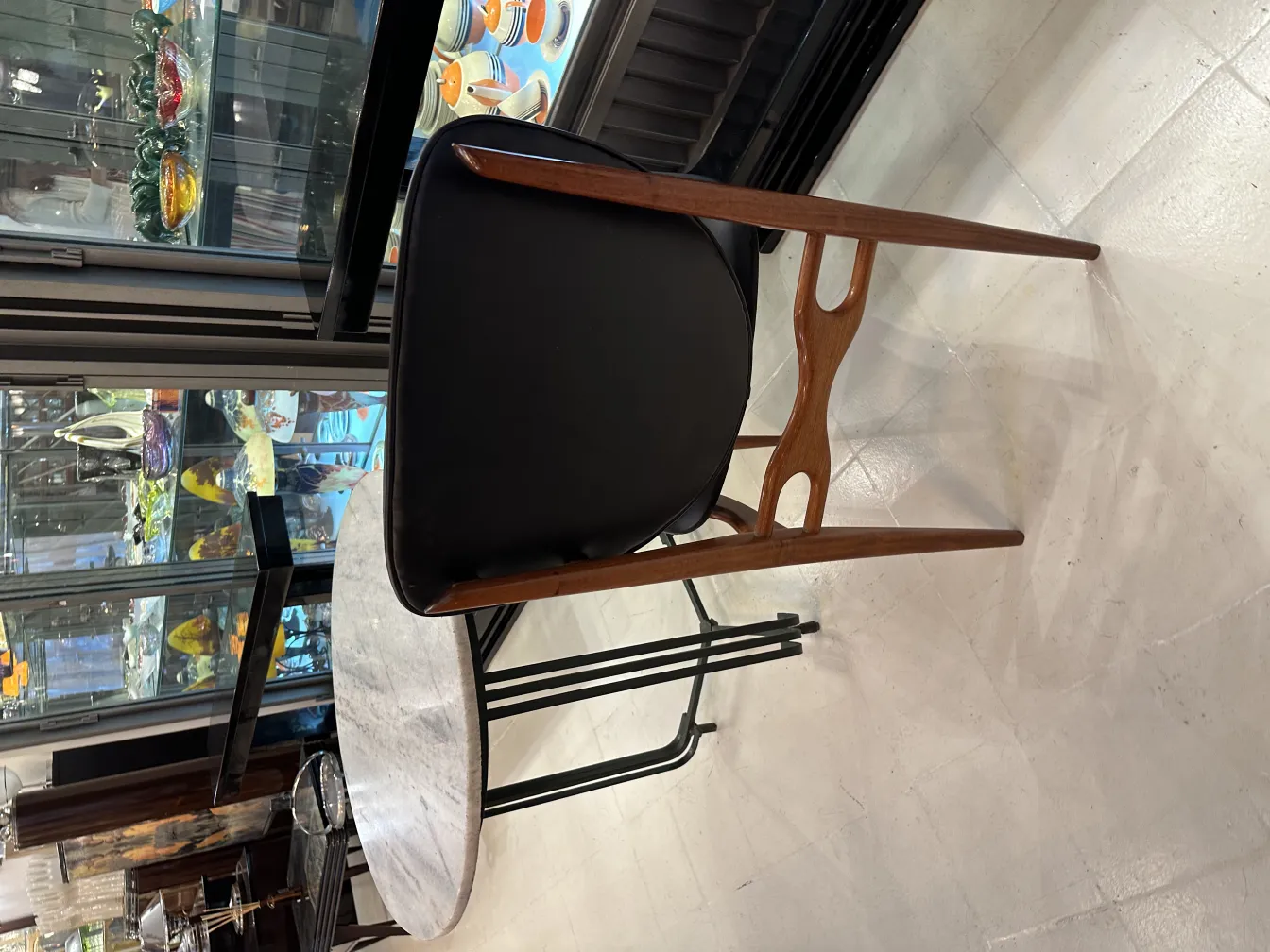 Ocho sillas antiguas en un entorno elegante con mesa y vitrinas