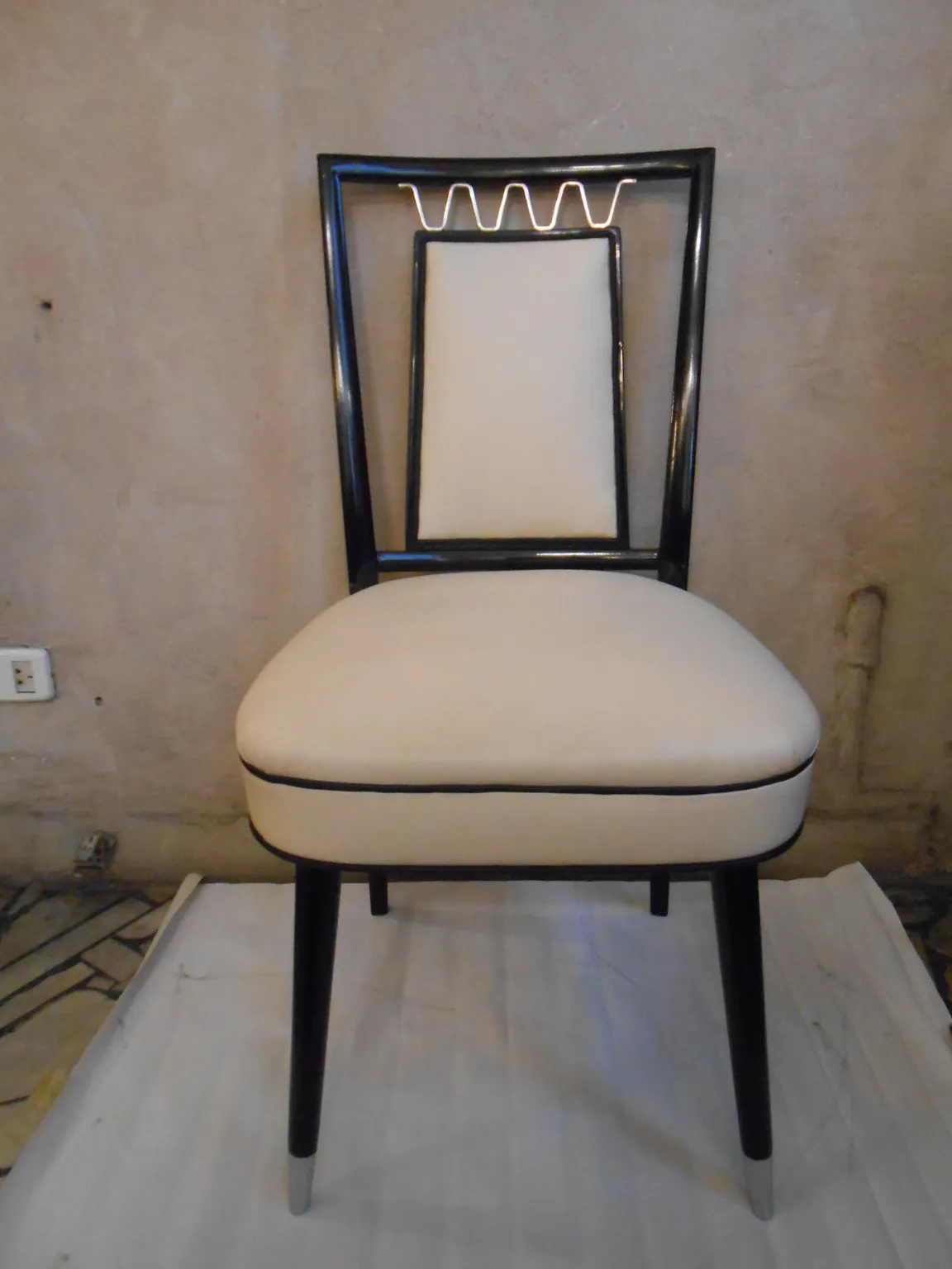 Elegant antique chairs with light seats and slender legs.