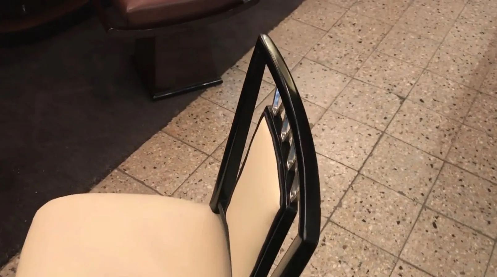 Side view of 10 antique chairs with elegant backs in a cozy setting