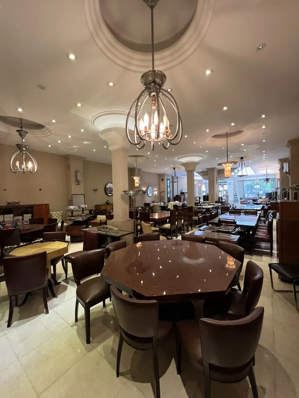 12 antique chairs surrounding a table in a restaurant
