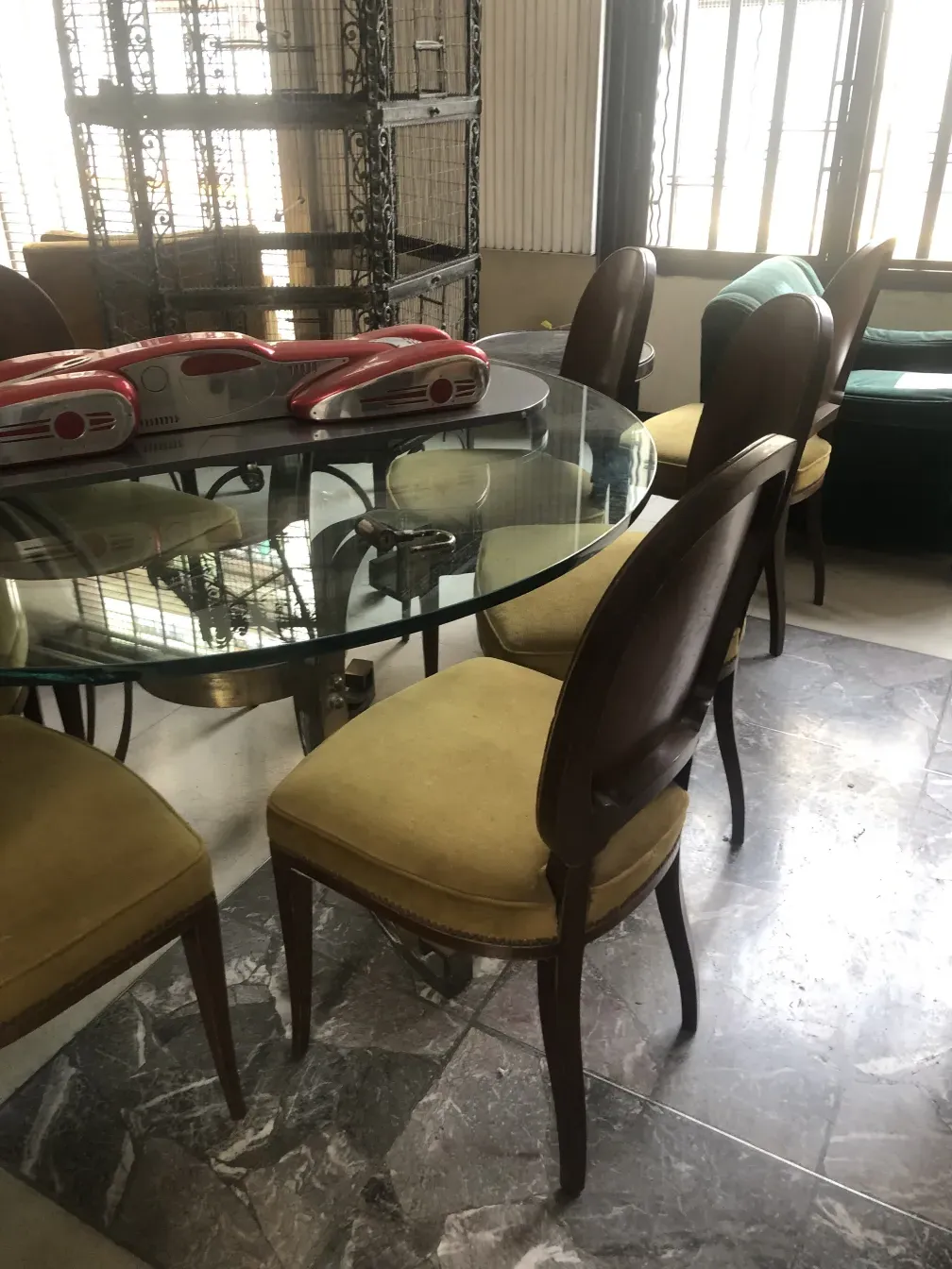 Round table with 12 antique chairs jansen in a well-lit setting