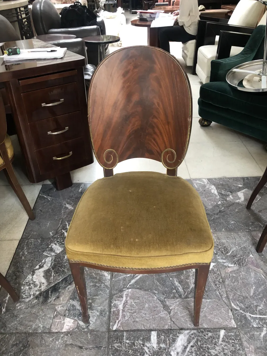 Front view of 12 antique chairs by Jansen in a classic setting.