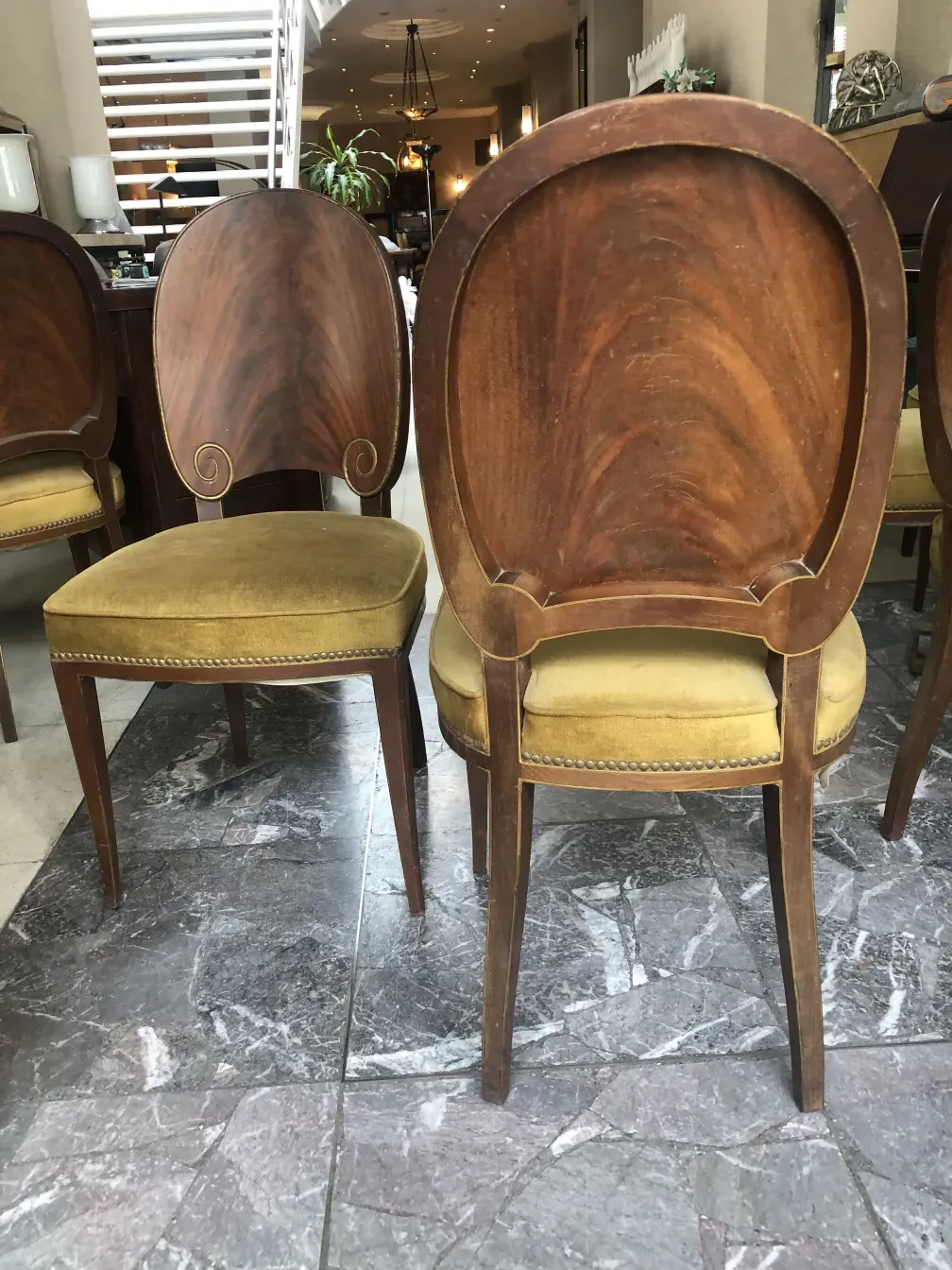 Rear view of 12 antique chairs with decorative details