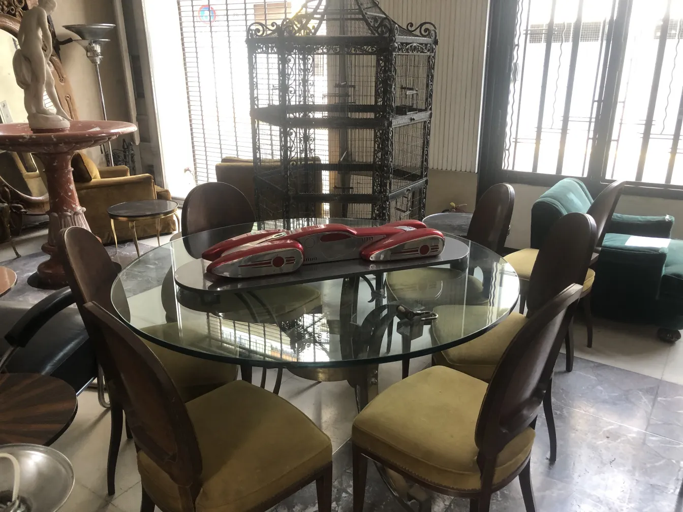 View of 12 antique chairs in a room with varied decor