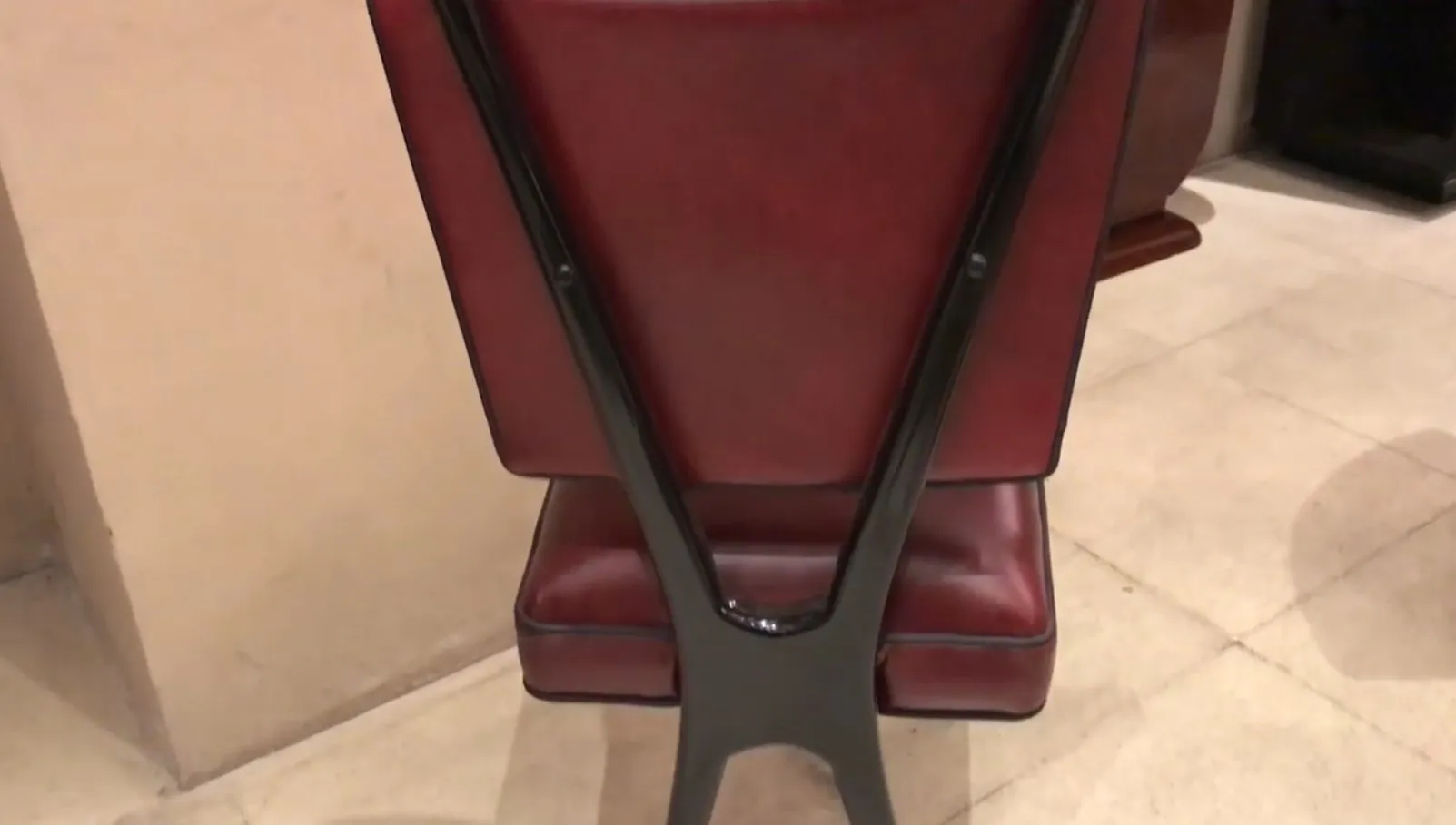 Back view of 12 antique chairs with elegant body and distinctive backrest in a classic setting.