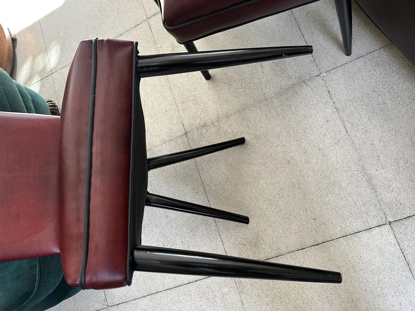 Side view of 12 antique chairs with modern design in a minimalist setting.