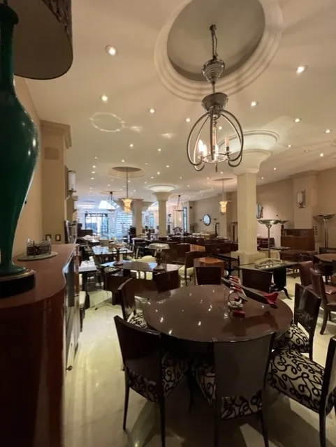 twelve antique chairs in an elegant restaurant with tables