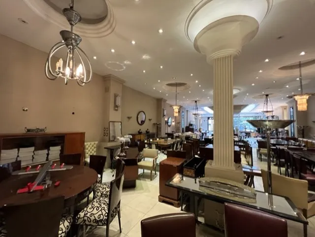 View of a setting with 12 elegant antique chairs surrounded by tables