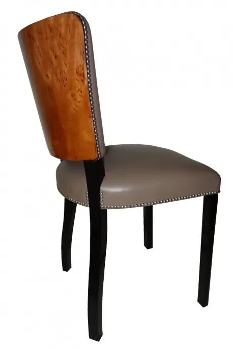 Side view of 12 antique chairs with unique backs on a light background