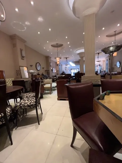 View of 12 antique chairs in an elegant restaurant with soft lights