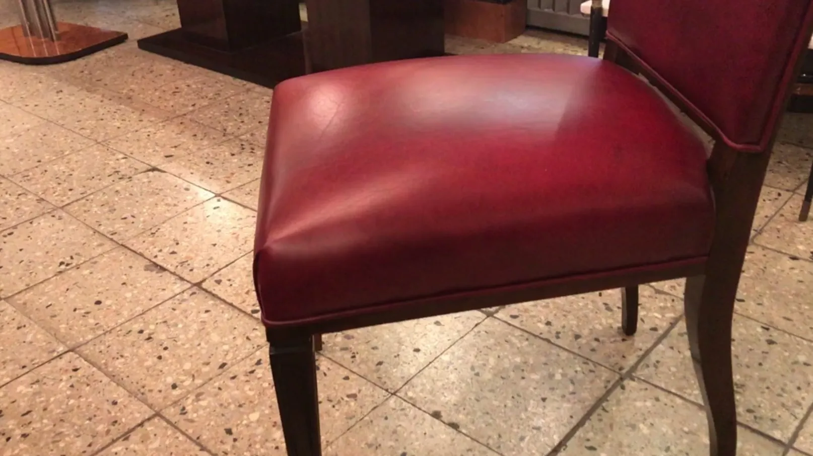 Detailed view of an antique red chair in an elegant setting
