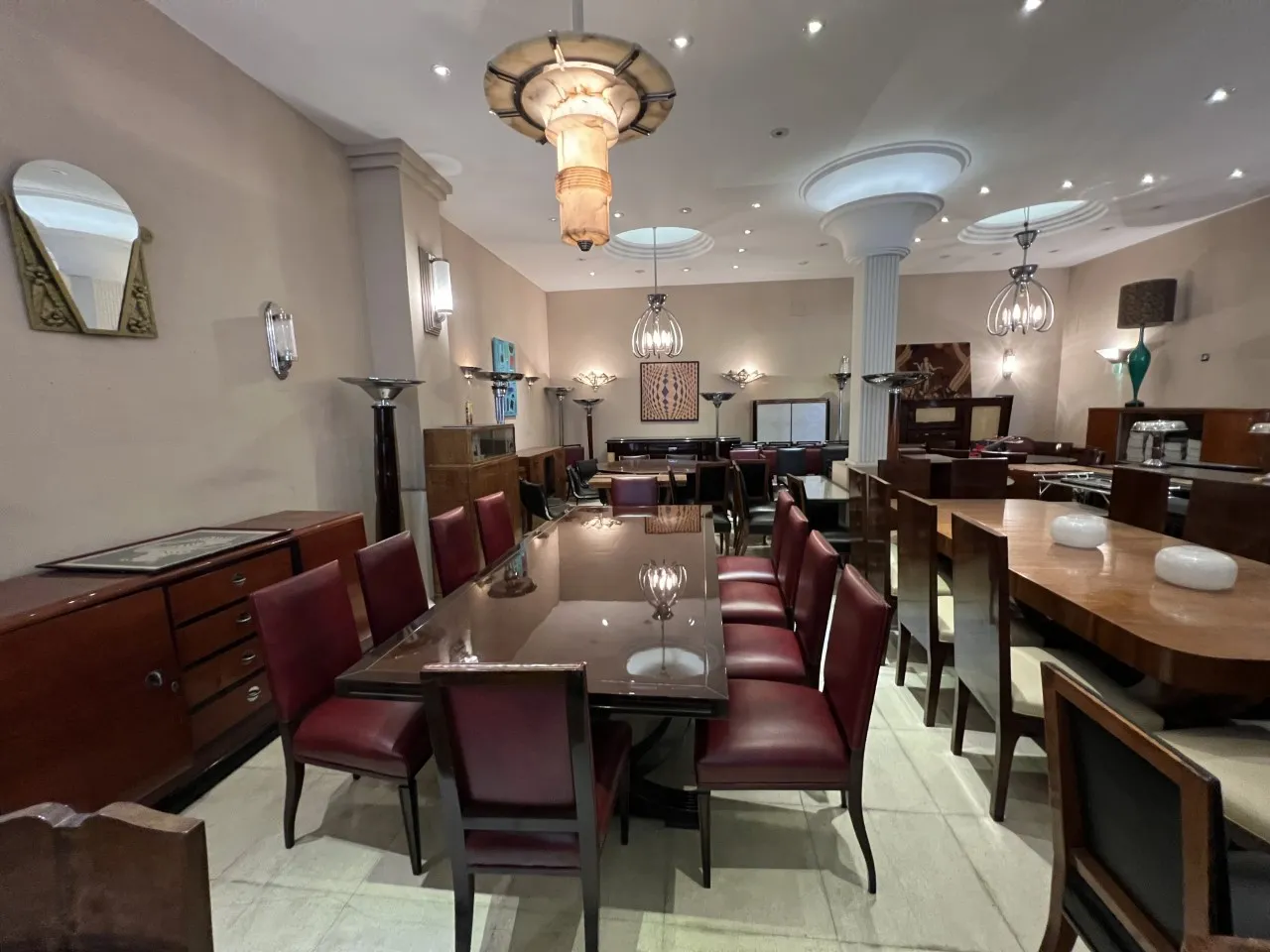 Comedor con 12 sillas antiguas, mesas y decoraciones elegantes