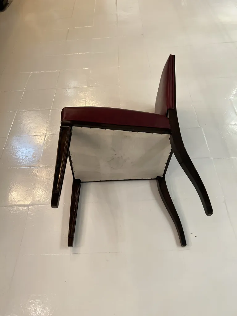 Imagem de 12 cadeiras antigas com design clássico, em um ambiente acolhedor