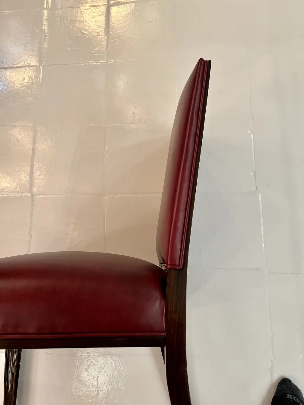 side view of an antique chair with red upholstery