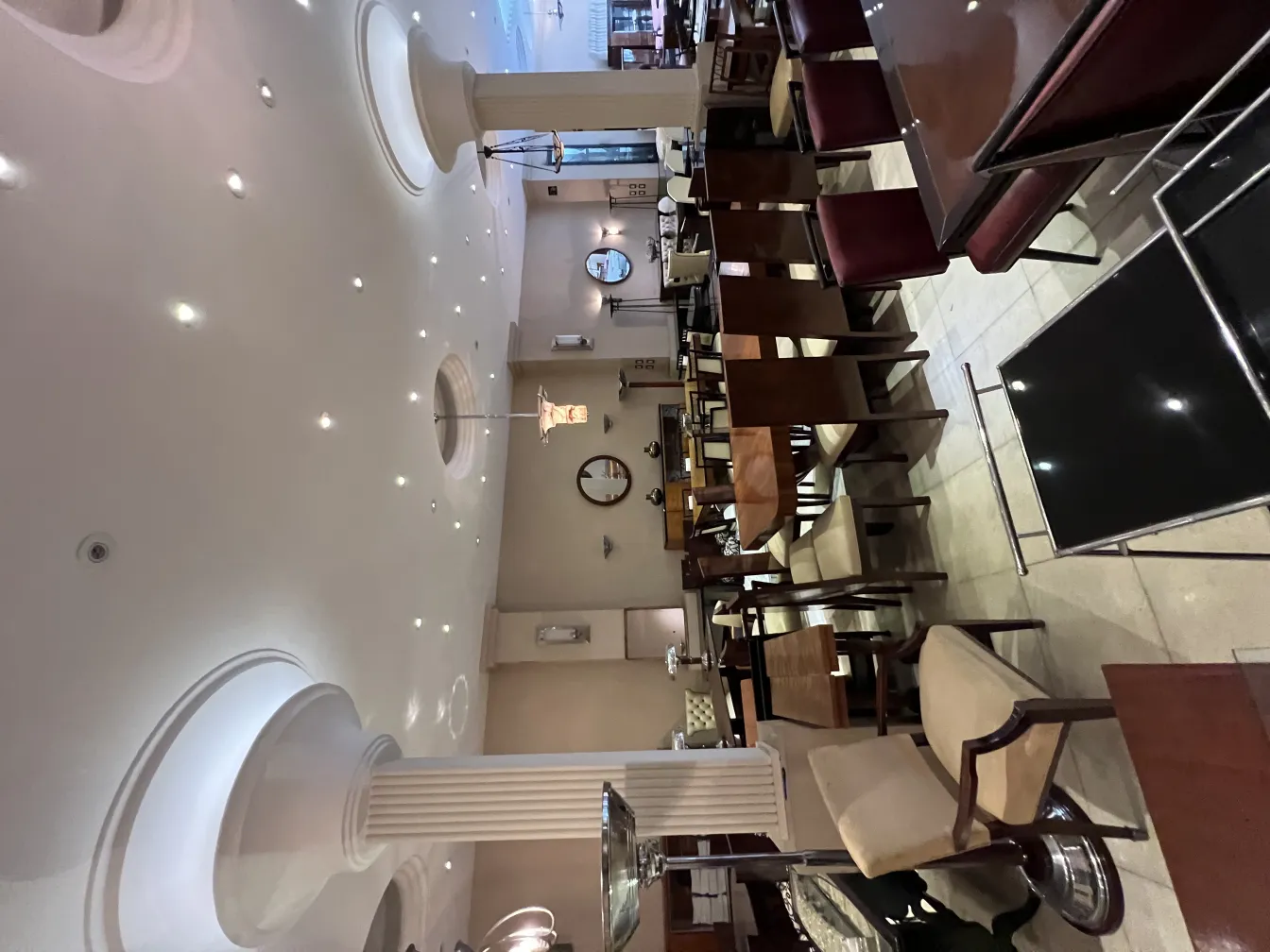 View of 12 antique chairs in a decorative setting