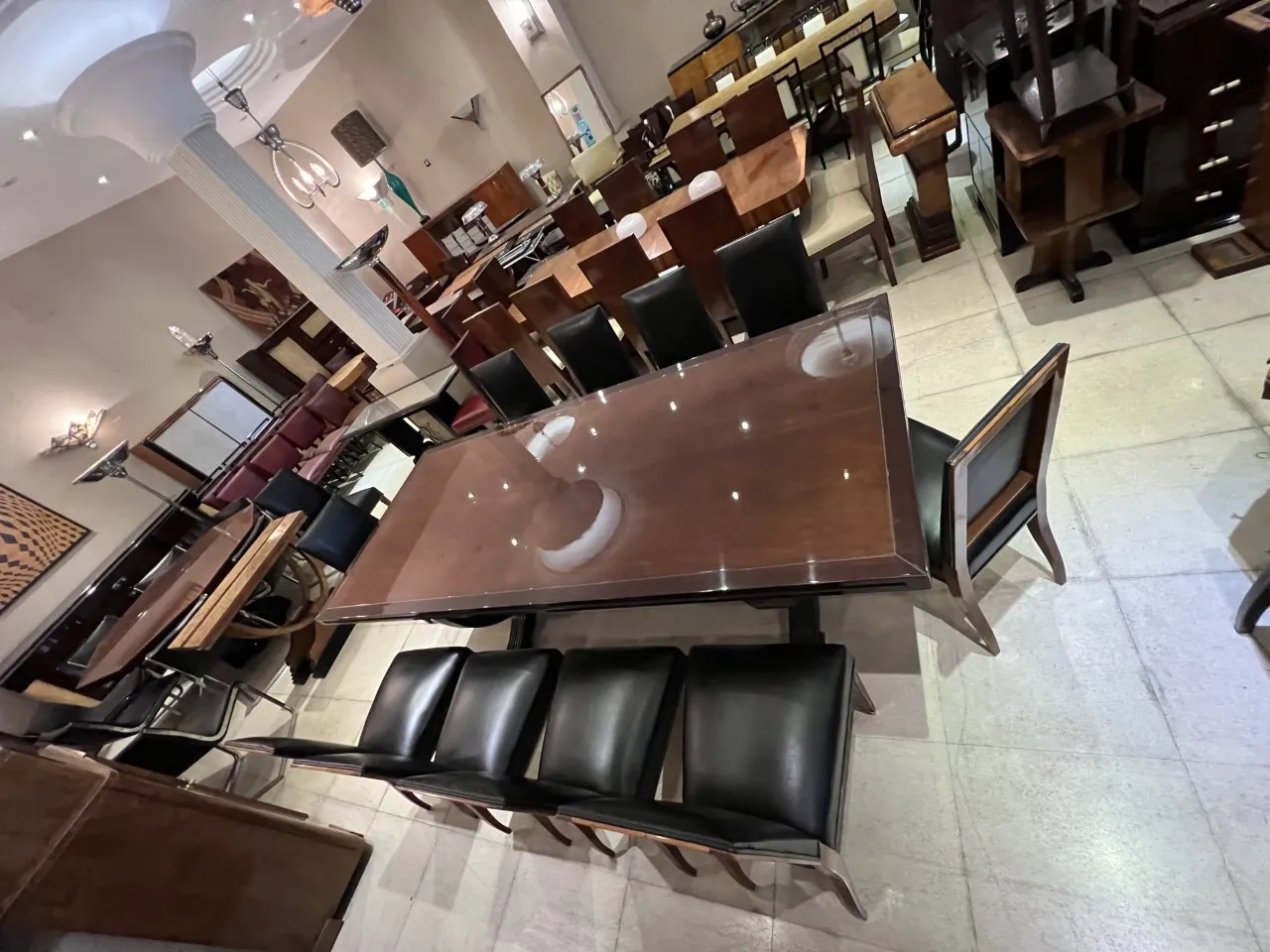 12 antique chairs in an elegant setting with a table