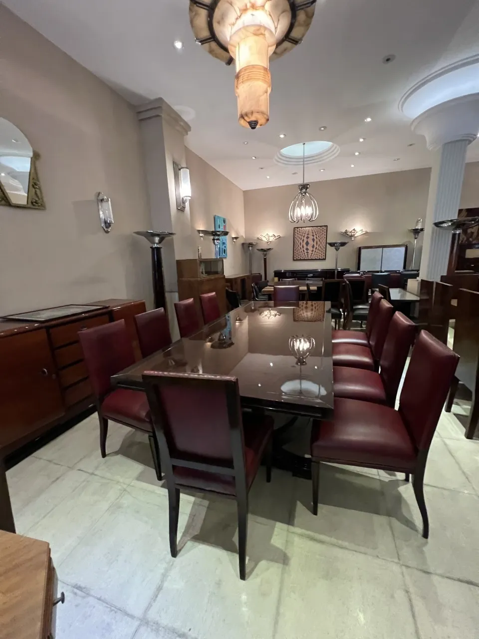 View of a dining room with antique 12 chairs in an elegant classic setting