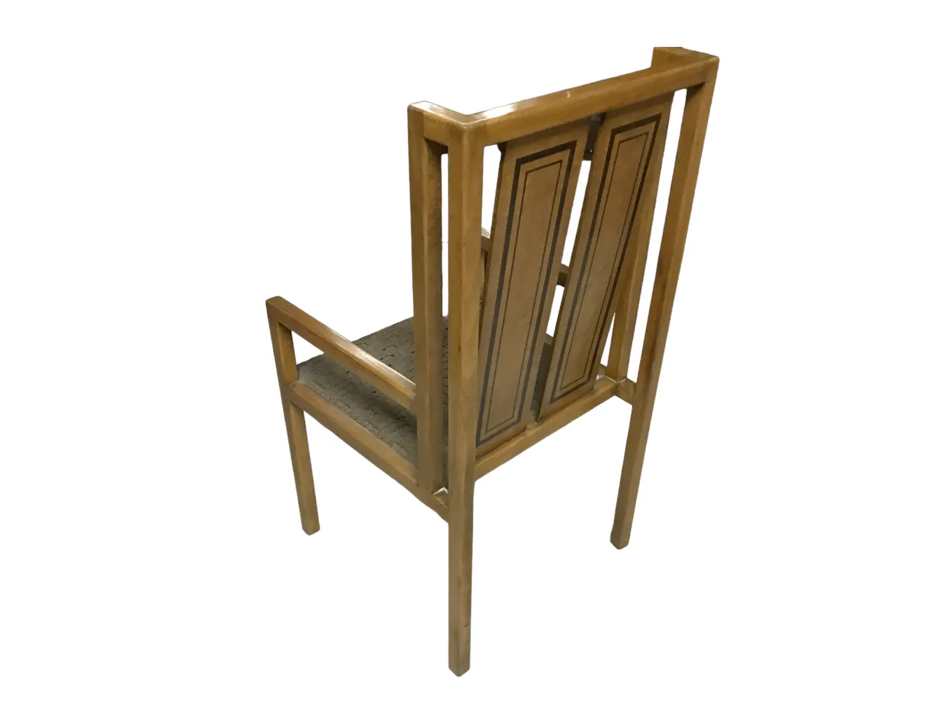 Antique chair with a tall back and decorative details, in a classic environment.