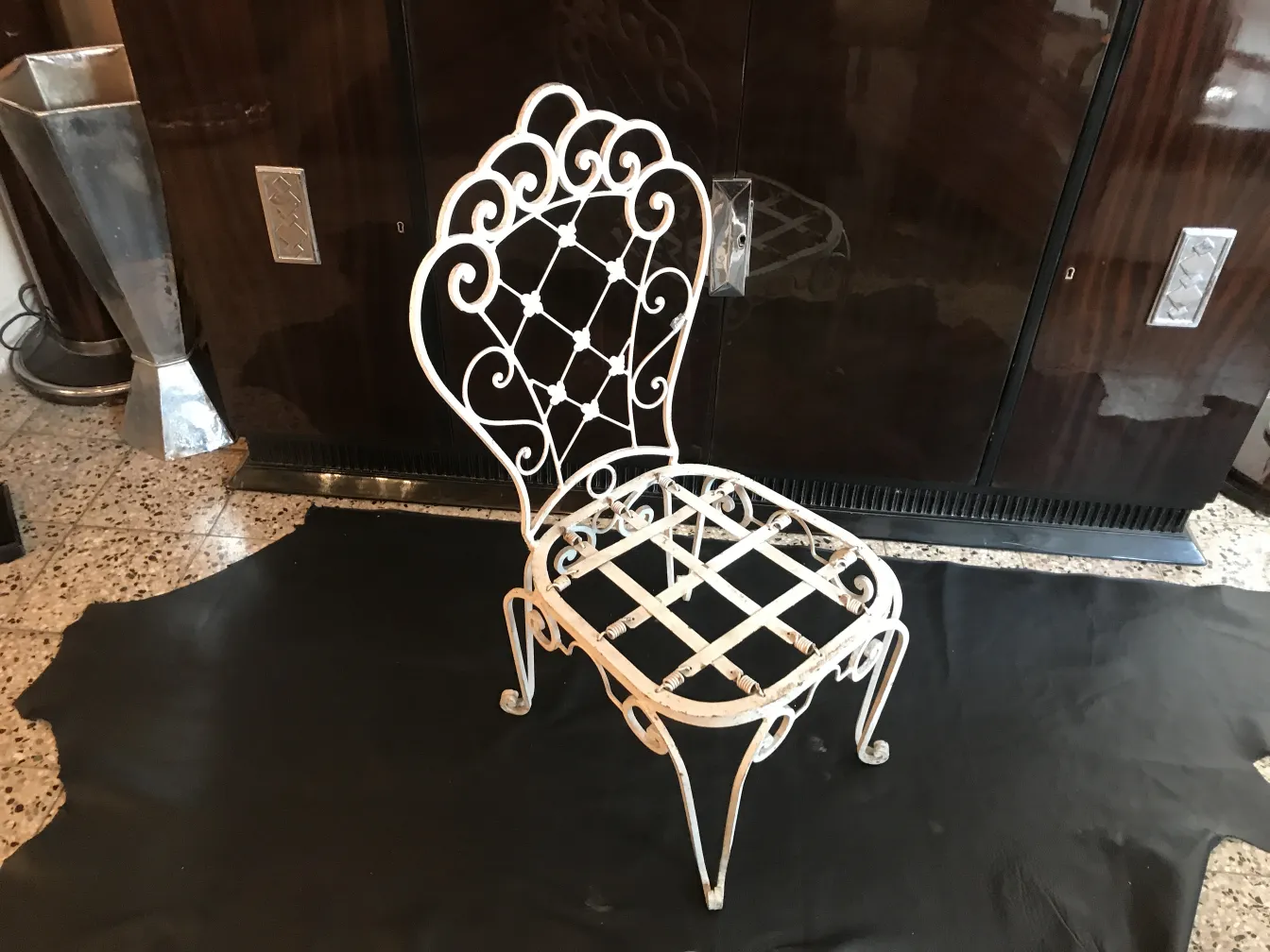 Antique garden chairs with ornate design, in a cozy setting.