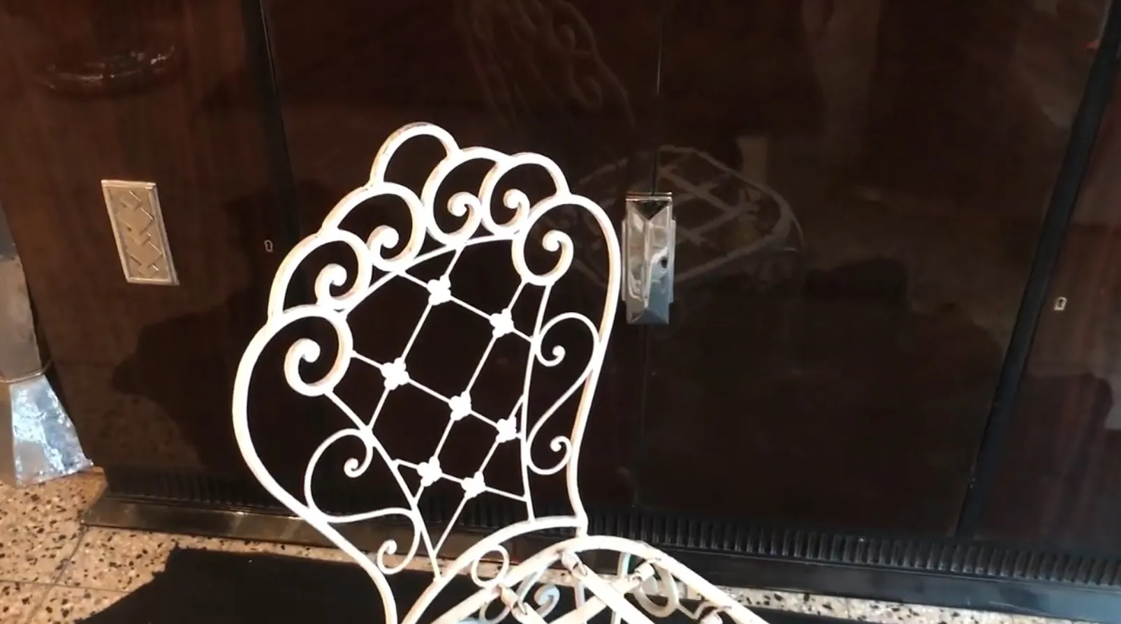 2 antique garden chairs with an intricate design in a cozy setting