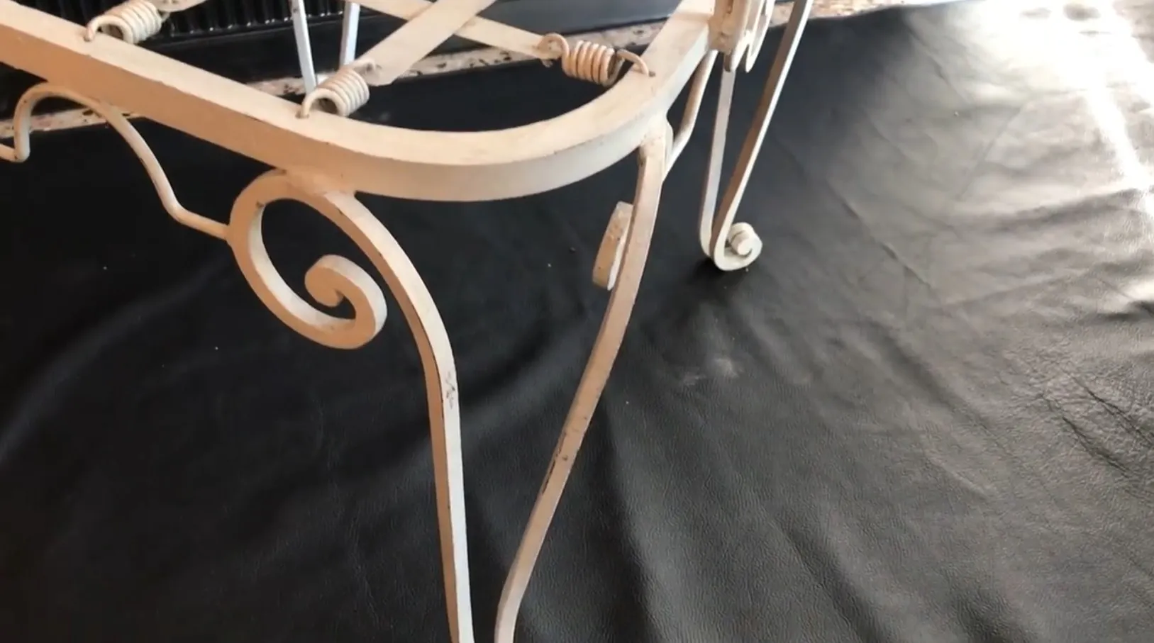 Side view of 2 vintage garden armchairs with decorative legs