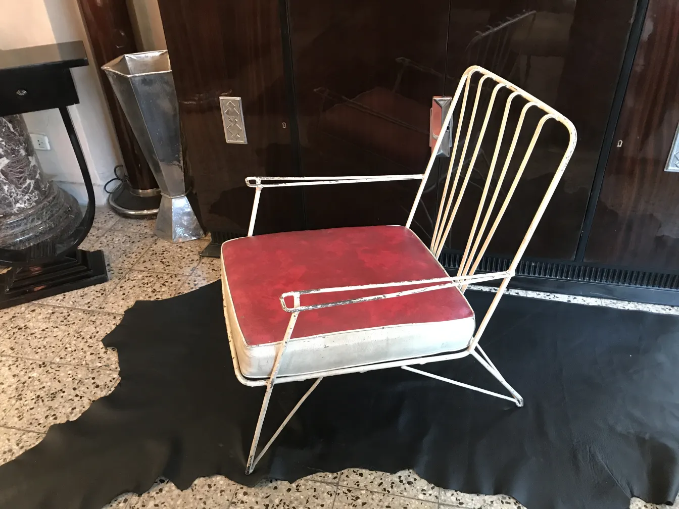 Antique garden armchairs with red and white accents in an elegant setting