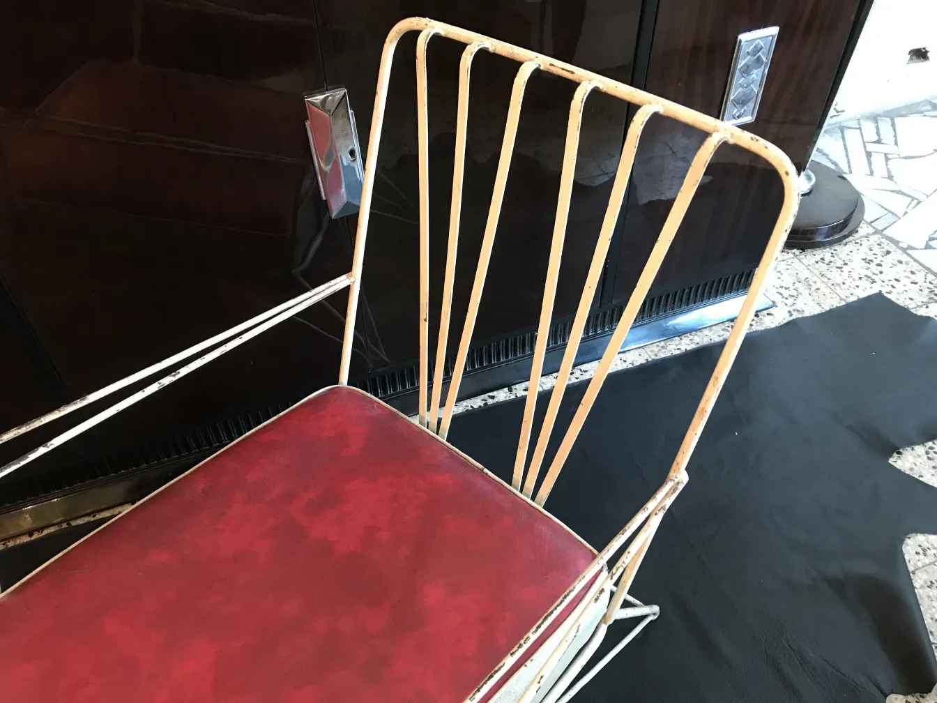 Antique garden armchairs with red seat and dark background
