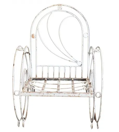 Three antique garden armchairs with an elegant design in a natural setting