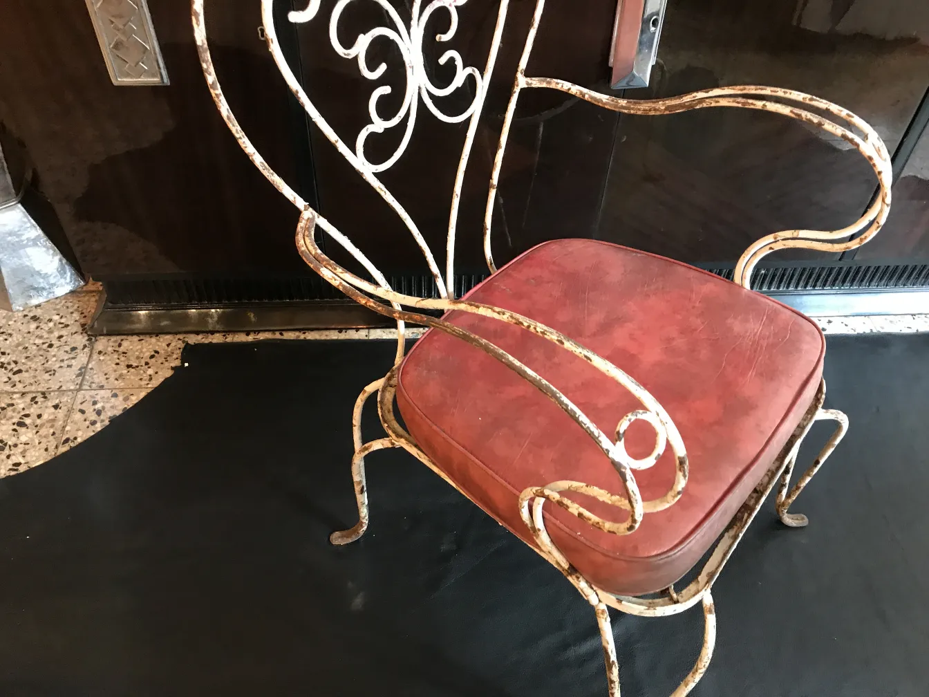 Three antique garden armchairs with arms in an elegant setting.