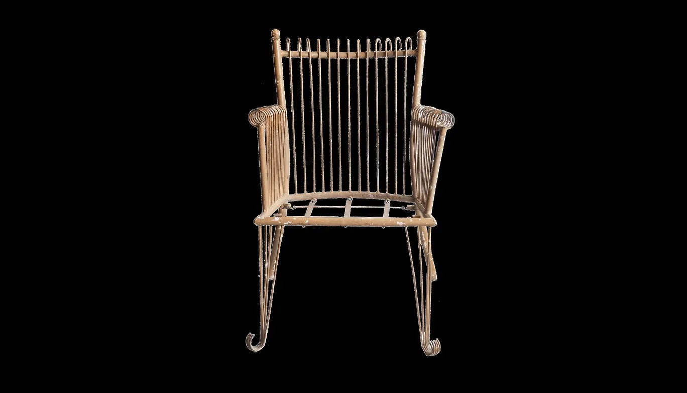 Four antique garden armchairs with elegant design and unique details, set in a natural environment