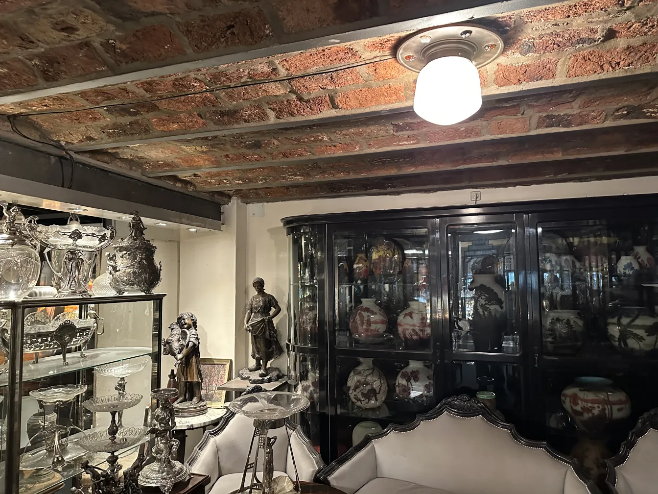 Antique ceiling light illuminating a room with decorative furniture.