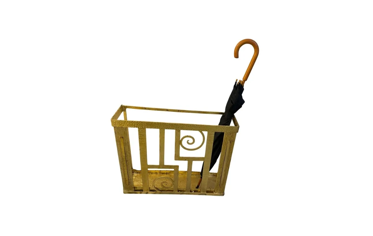 Antique umbrella stand with decorative details and black umbrella