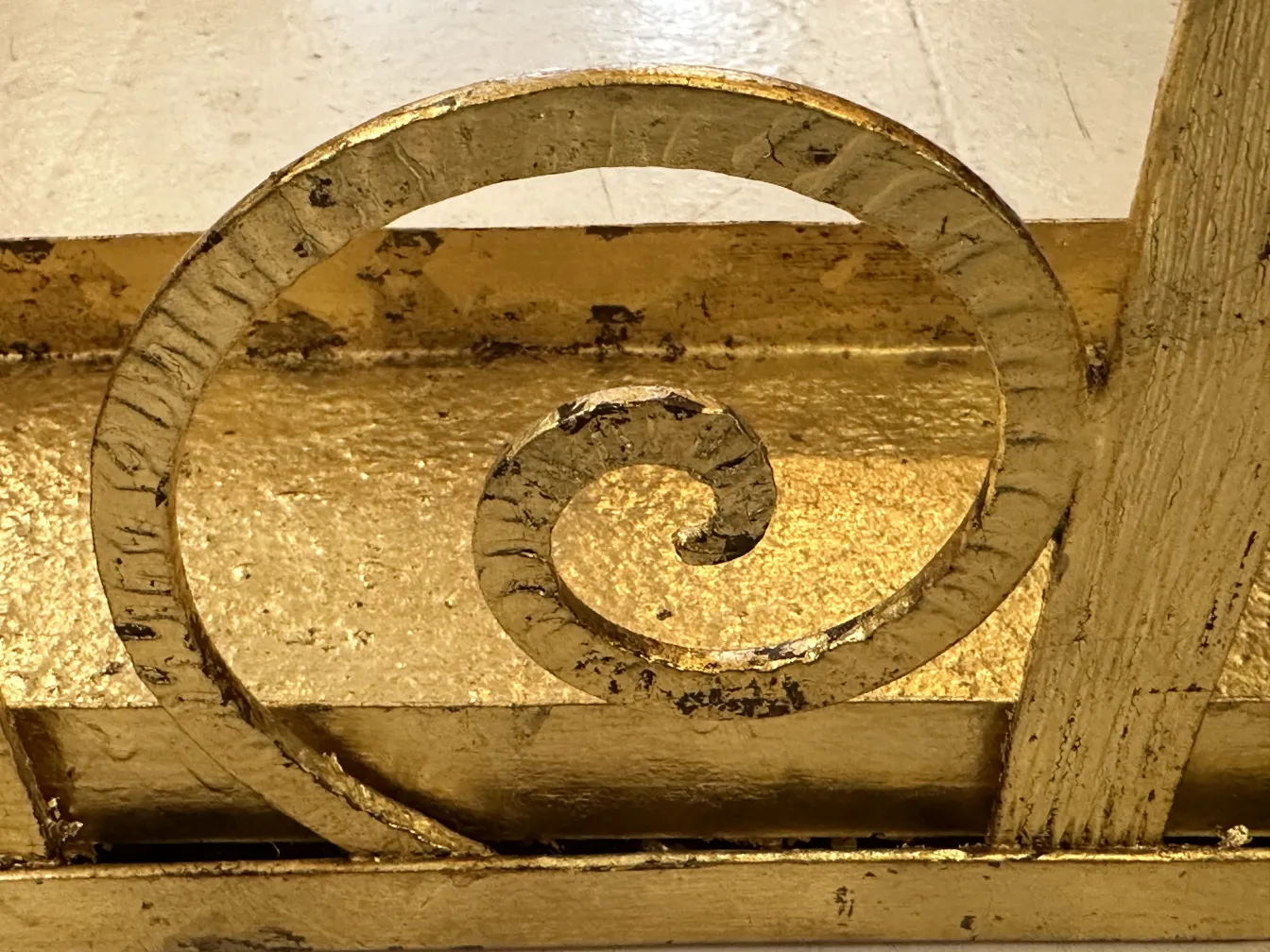 Suporte para guarda-chuva antigo com design dourado, detalhes decorativos, ambiente elegante.