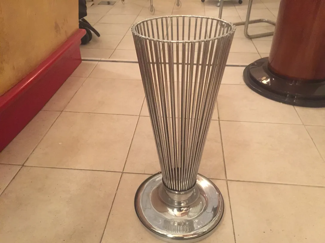 antique umbrella stand with cylindrical shape and circular base