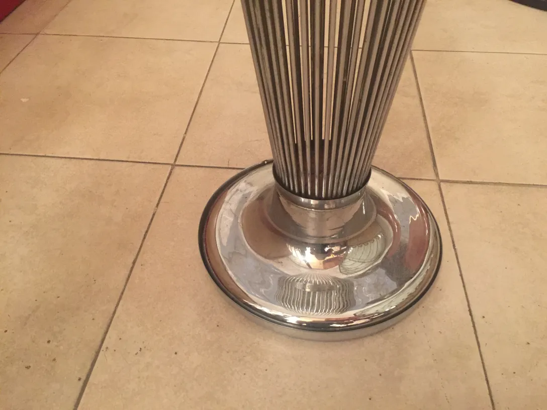 antique shiny metal umbrella stand in a neutral setting