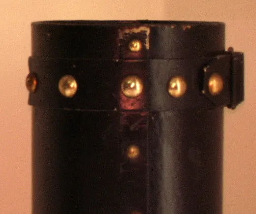 antique cylindrical umbrella stand decorated with golden studs