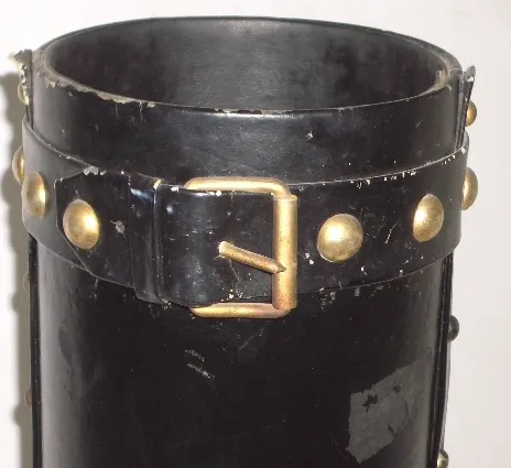 black antique umbrella stand with gold details and buckle